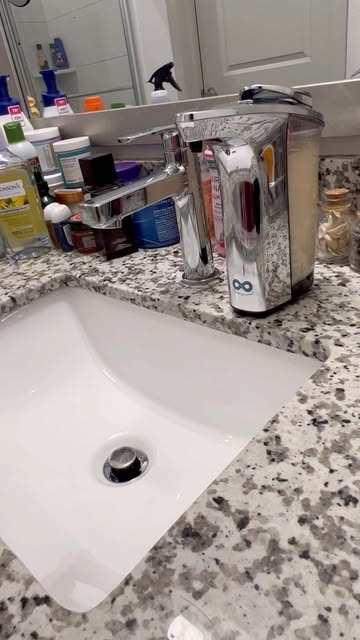 A Stylish , Touch-less, Fancy, yet elegant soap dispenser with a clear metal chrome-like container, perfect for a mod...