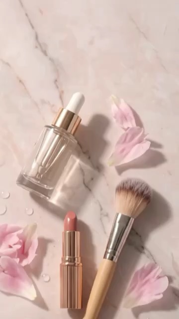 Luxe Pastel Beauty Flat-Lay with Serum, Lipstick, Brush and Peony Petals on Pink Marble