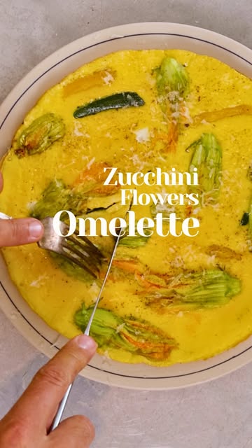 Zucchini flower omelette. 5 eggs, but I kept only 3 yolks — lighter, still rich. Baby zucchini straight from the stem...